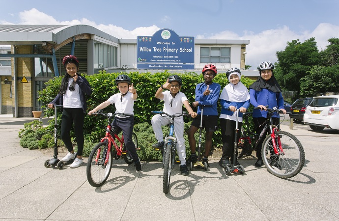 Pupils at Willow Tree Primary School on bikes and scooters