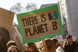 Placard saying 'There is no planet B' being held aloft at a protest