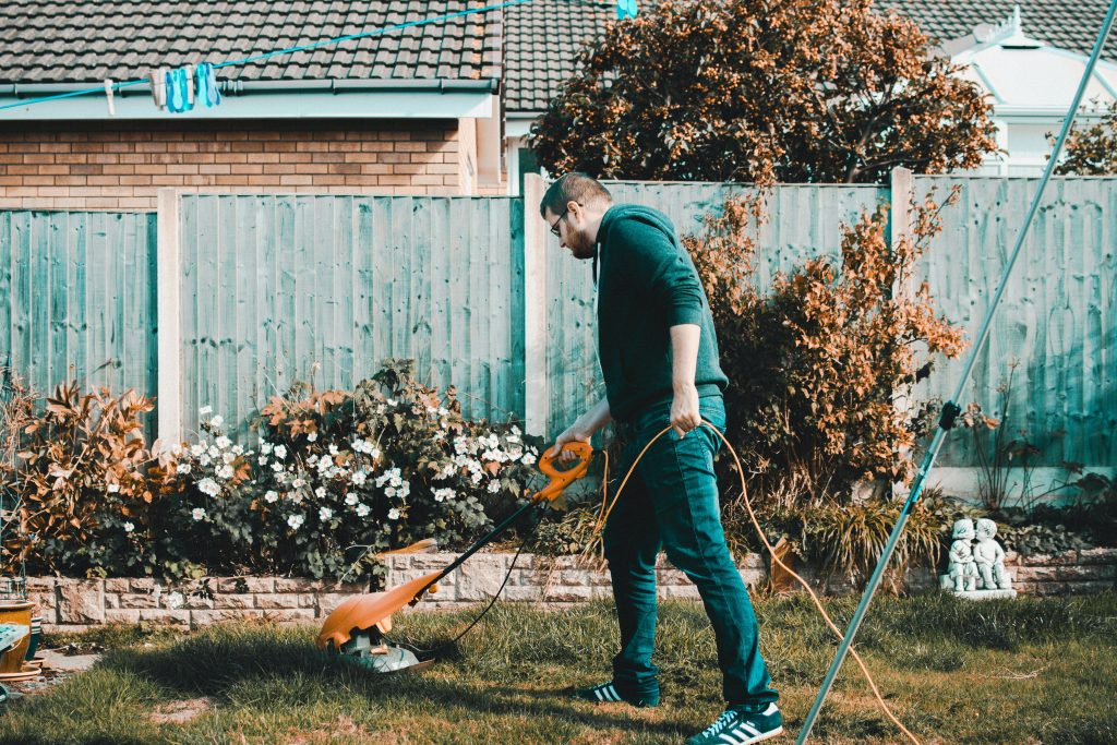 man mowing lawn in garden