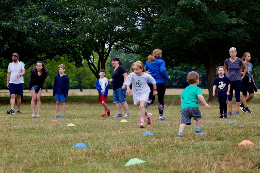 Children running on grass in a park