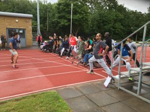 People on a running track, warming up for a race