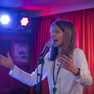 Comedian Sonia Aste performing on stage