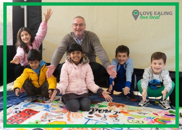 John Martin and children from Pitshanger Lane working on community art canvas