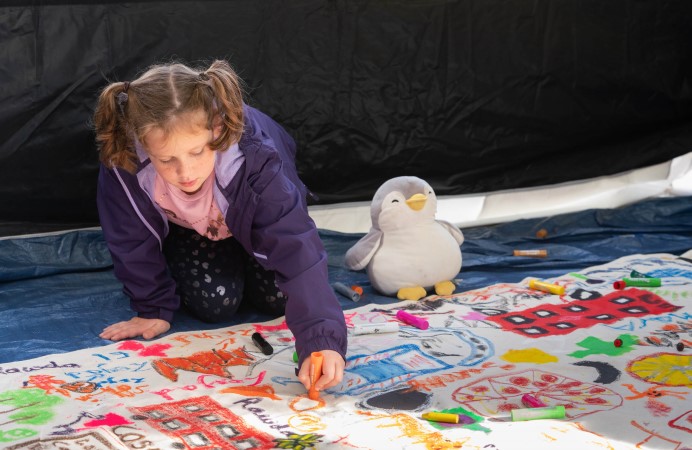 Child colouring on canvas