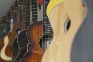 A row of guitars hanging in a musical instrument shop