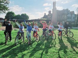 Cyclists in a row, smiling