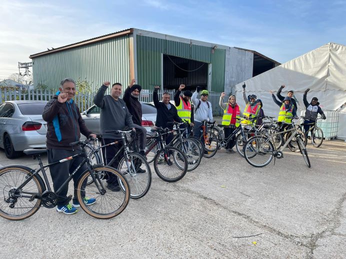 Cyclists in a row, smiling