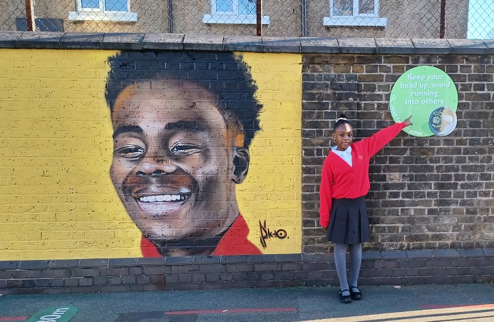 Painting of Bukayo Saka with Myla Clarke-Williams, pupil at Edward Betham school