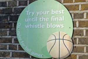 Football rule on school playground wall - Try your best until the final whistle blows