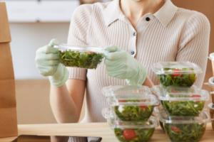 Woman preparing food in plastic containters