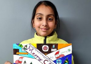 Kinza Habib Raza (female) holding her Christmas card entry