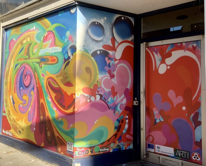 Art piece by Morgan Davy - swirling colourful images with hearts in shop window