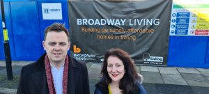 A man and a woman standing outside a new housing development