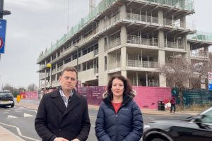 Councillor Peter Mason and Lauren Wall outside a tall building in the street