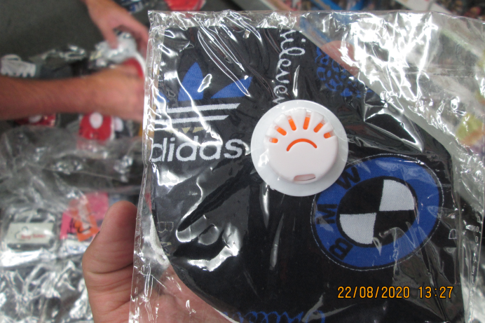 A fake Adidas face mask in plastic wrapping