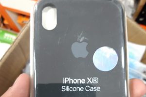 Fake Apple iPhone plastic case held in someone's hand