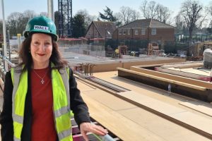 Councillor Lauren Wall wearing a hard hat and high viz jacket at a building site
