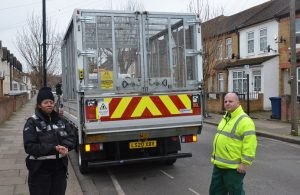 Two members of the council's fly-tipping team next to their truck
