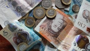 Pound stirling notes and coins on a table