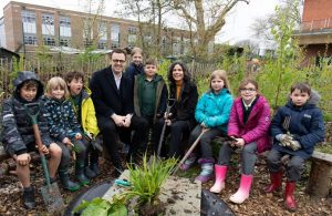 Cllrs Costigan and Mason with children sitting in garden