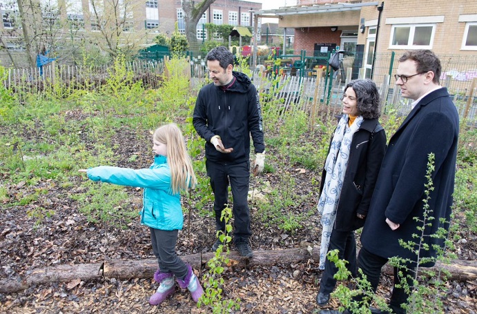 young girl pointing with teacher and Cllrs Mason and Costigan