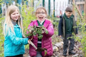 Two girls very excited in the garden