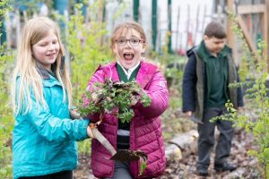 Two girls very excited in the garden