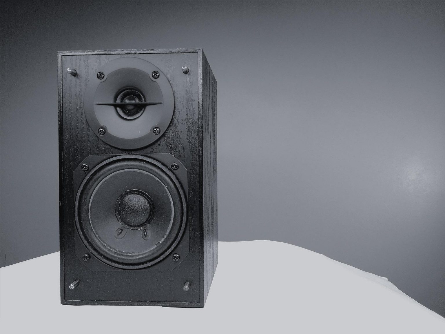 A black speaker on a white table