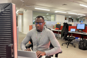 Animal licensing officer Shane sitting in front of his computer in an office setting