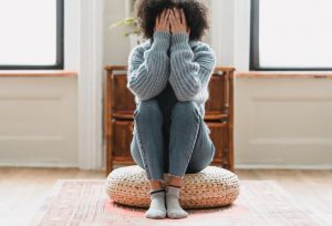 Distressed woman with her head in her hands
