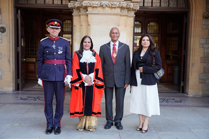4 adults, 2 male, 2 female outside Ealing Town Hall. From left to right Richard Kornicki CBE DL, Councillor Mohinder Kaur Midha, Mr Harbans Midha and Miss Urvashi Chand