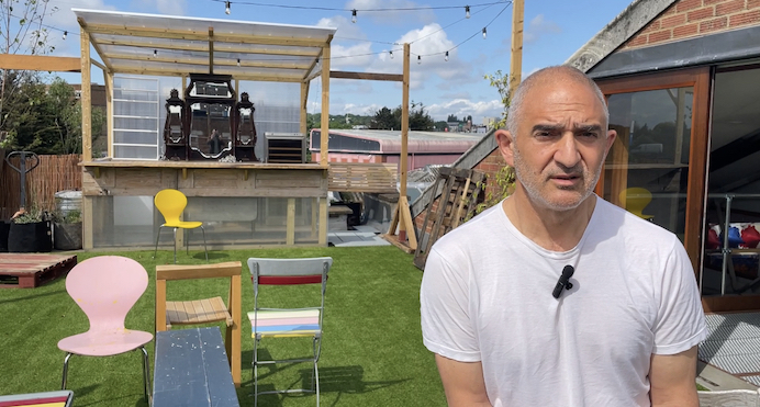 Henry Kroakatsis, founder of Queensrollahouse seated on the roof terrace at the studio