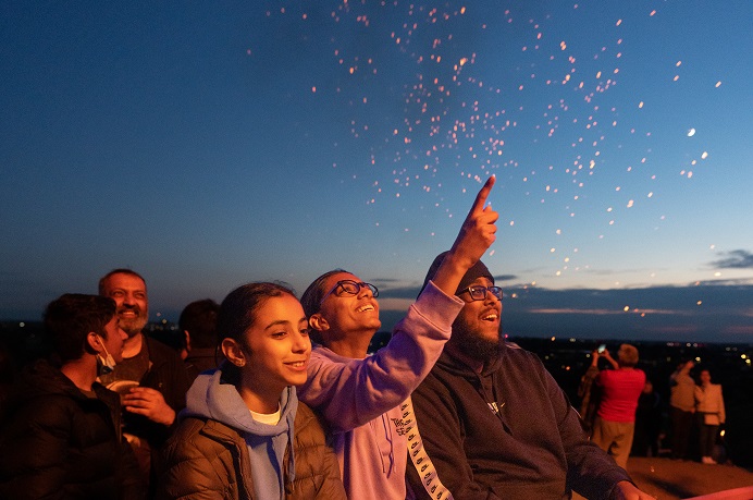 Group of young people looking up at the sky