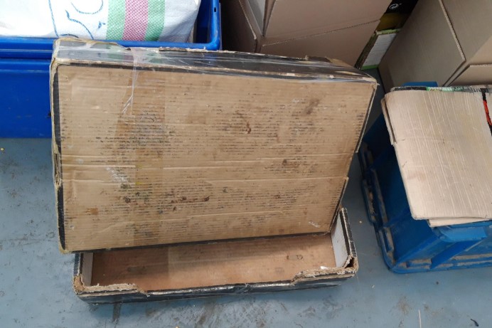 Dirty cardboard box stored in a cupboard