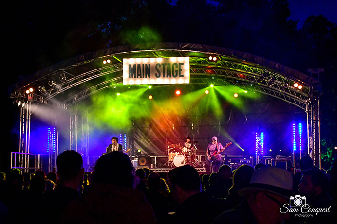 Stage with band on, at night, with coloured lights