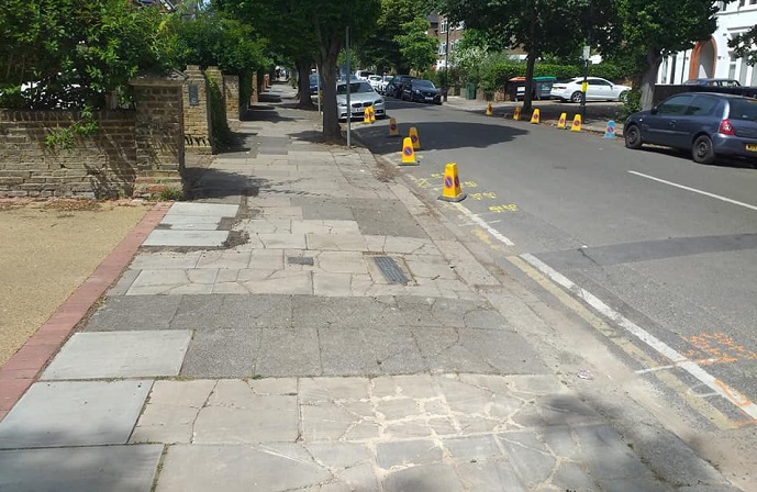 Suburban street showing cracked and damaged paving