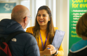 Two people talking at a careers fair