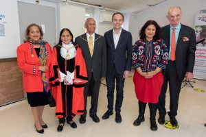 Group of men and women, including the mayor, smiling