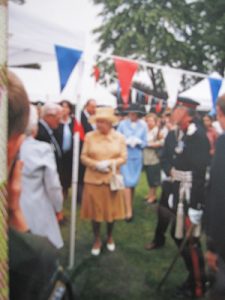 Bunting in the foreground and the Queen surrounded by people