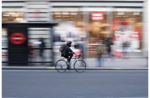 Cyclist whizzing pass on road