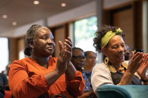 Two women applauding