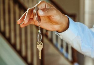 A landlord handing over keys to their tenant