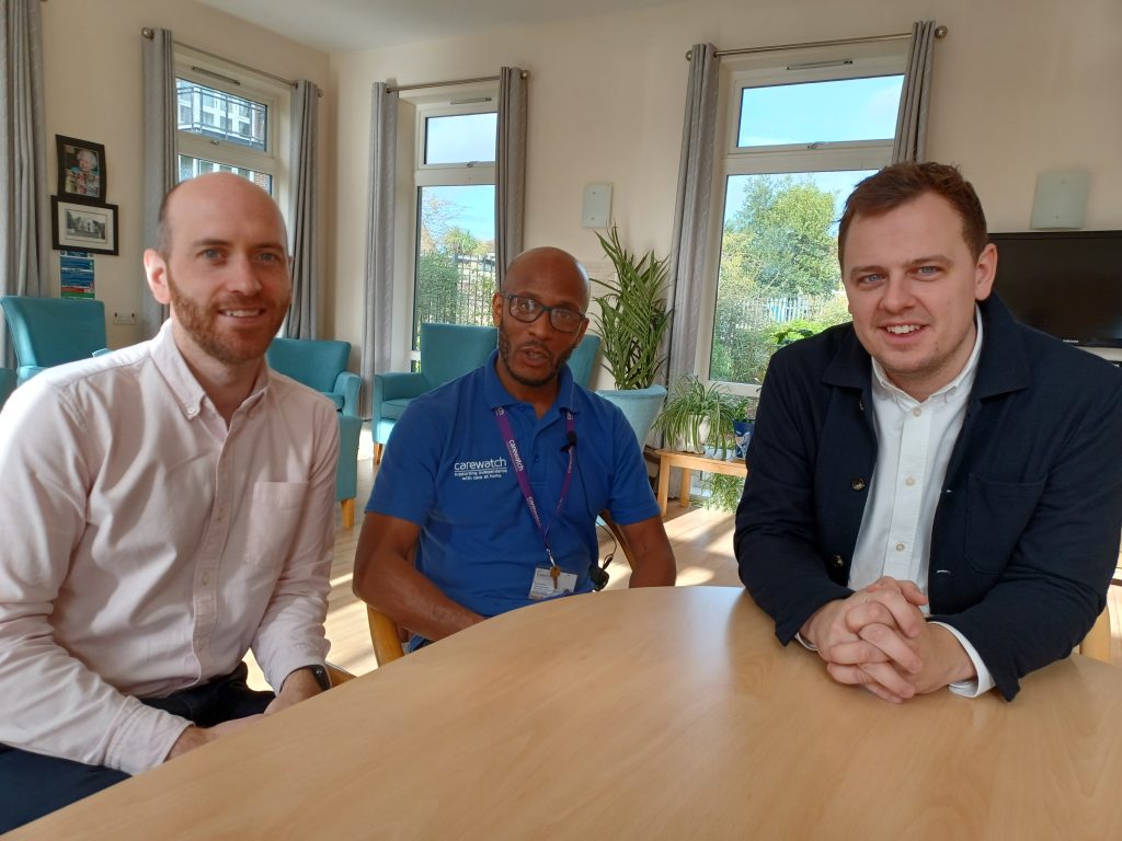 Three men sitting at a table - including councillors Black and Mason