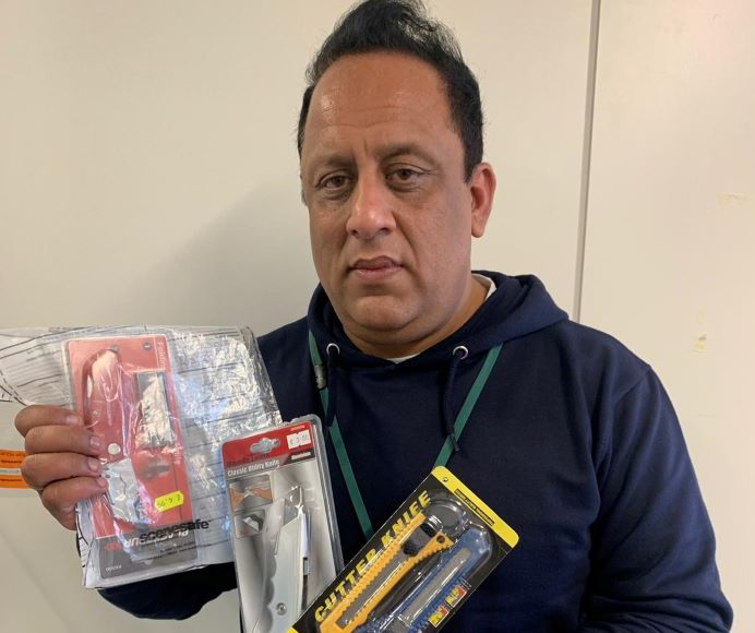 Trading standards office Tariq holding knives seized in underage purchasing operation