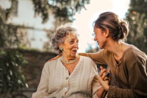 Woman chatting to older woman