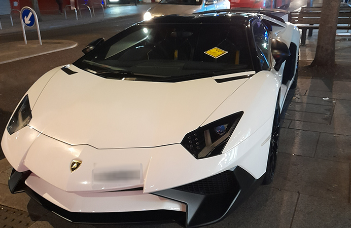 Sports car with parking ticket notice on the windscreen