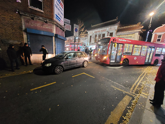 Car parked badly on street with bus trying to get past