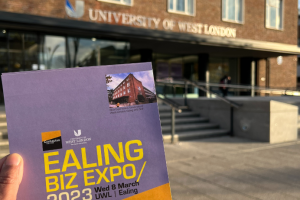 Ealing Business Expo 2023 brochure held in front of University of West London building