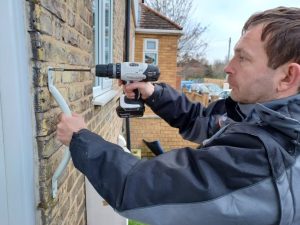 Man drilling into wall