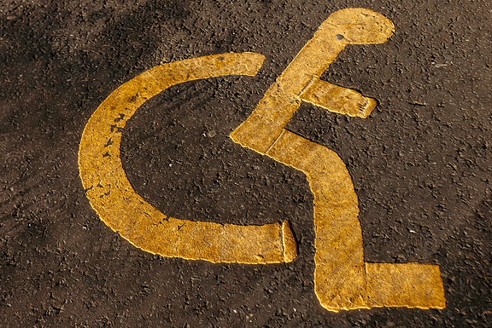 Yellow disabled road sign painted on the road